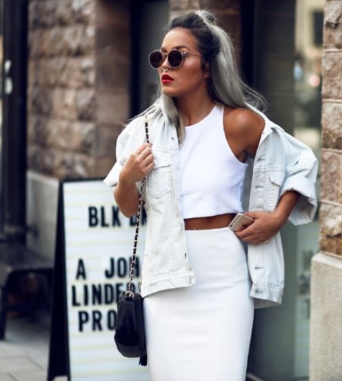 a total white look with a crop top, a pencil skirt, a white oversized denim jacket and a black bag