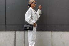 39 an all-white outfit with a denim jacket, jeans, black sneakers and a black crossbody bag