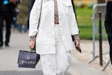 42 white jeans, an oversized denim jacket, a printed crop top, white trainers and a grey bag