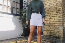 44 a fall outfit with a green jumper, a white denim mini skirt, black boots, a black belt and a black bag