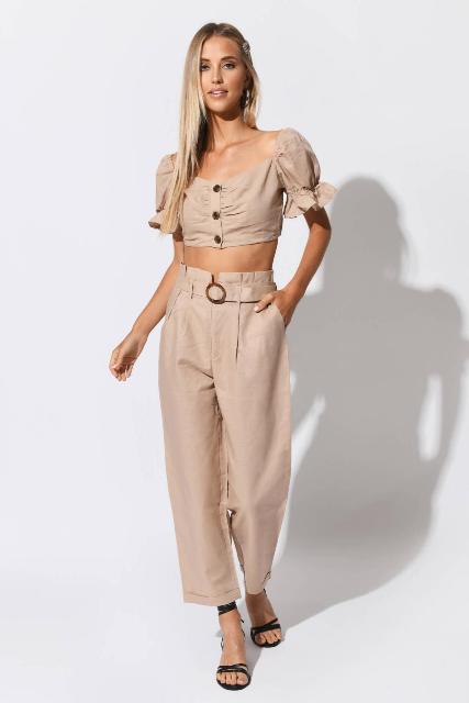 With beige puff sleeved crop button down shirt and black ankle strap low heeled shoes
