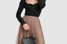 With black puff sleeved blouse and black leather bag