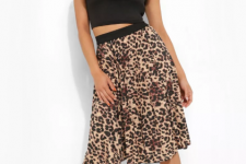 With black sleeveless cropped top and black and golden ankle strap high heels
