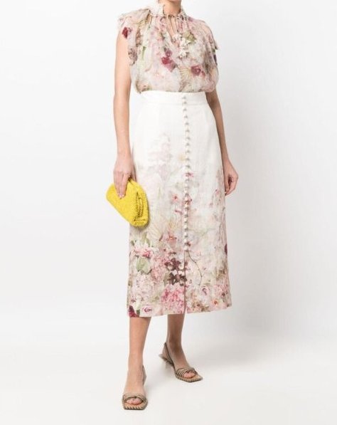 With floral printed ruffled blouse, yellow clutch and beige leather low heeled shoes