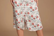 With floral printed sleeveless top and white leather low heeled shoes
