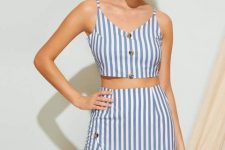 With golden earrings, straw basket bag and blue and white striped sleeveless crop top