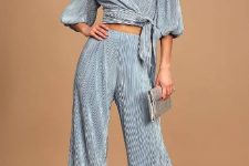 With gray pleated wrap crop shirt, silver leather clutch and silver leather high heels