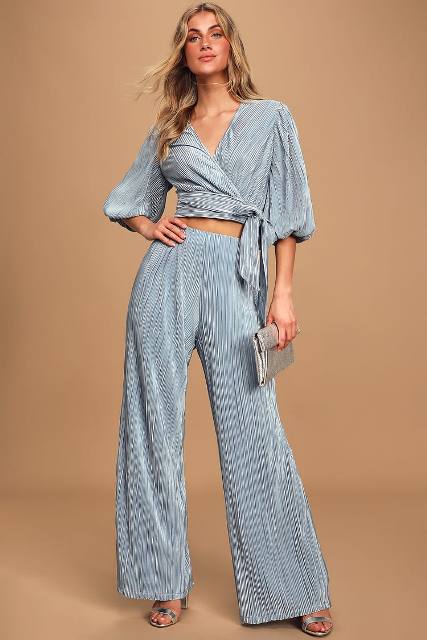 With gray pleated wrap crop shirt, silver leather clutch and silver leather high heels