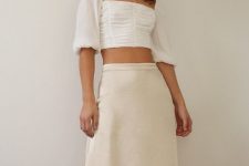 With necklace and white puff sleeved crop shirt