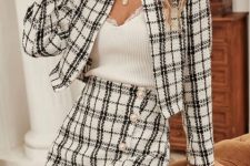 With necklace, white lace top and black and white checked collarless crop jacket