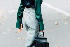 With oversized sunglasses, light gray high-waisted pants, black leather bag and black leather heeled shoes