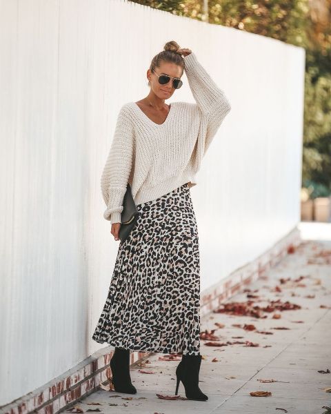 With sunglasses, white oversized sweater, black leather clutch and black suede ankle boots