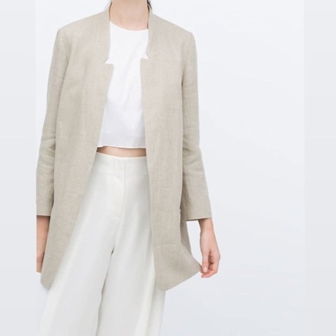 With white crop top and beige high waisted pants
