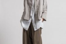 With white linen loose button down shirt, dark gray linen culottes and black leather cutout flat sandals