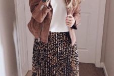 With white loose top, brown suede jacket and beige patent leather pumps