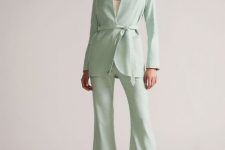 With white top, mint green linen flare pants and silver embellished high heels