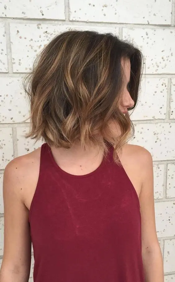 a black bob with caramel balayage and waves is a beautiful and eye catchy idea with plenty of contrast