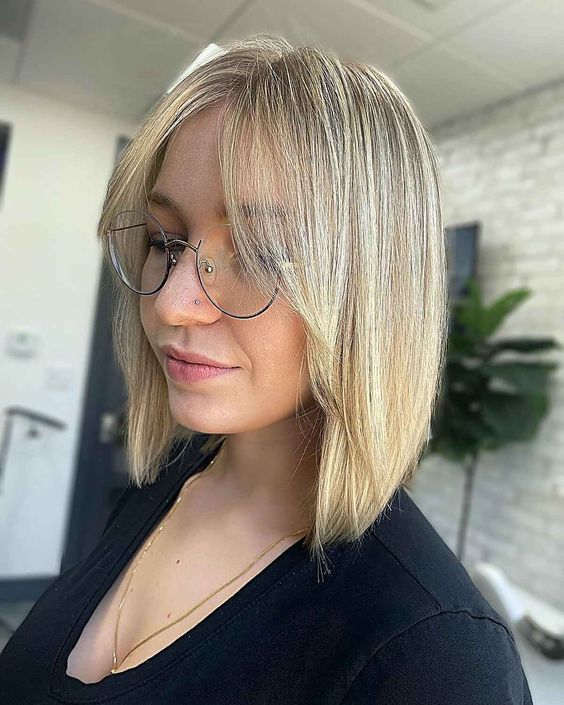 a blonde A-line long bob with curtain bangs is a lovely and cute idea with a classic hair color but a twist with its angle