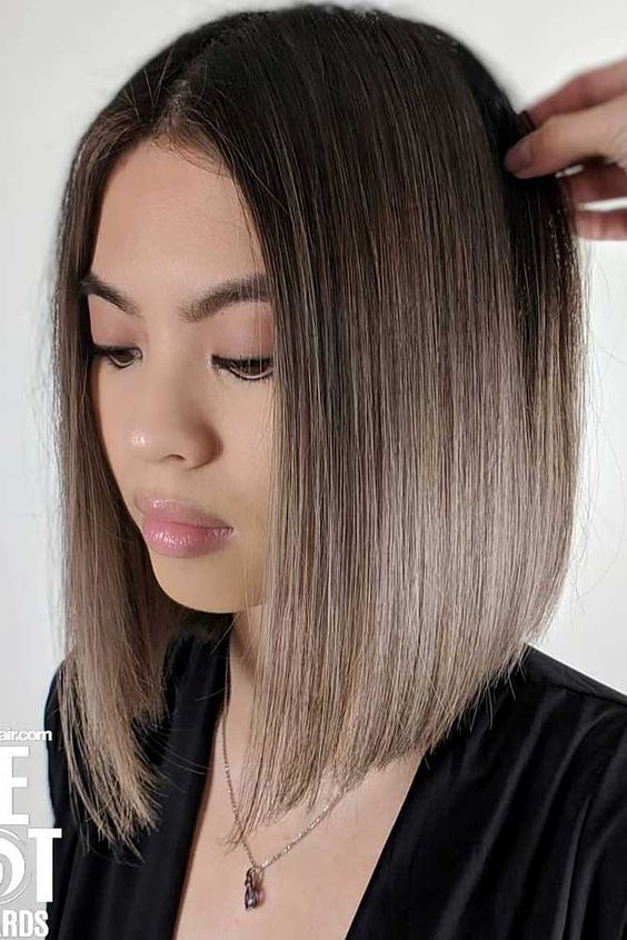 a blunt bob with a black root and mousy brown ombre hair is a chic and bold idea that looks sleek and catchy