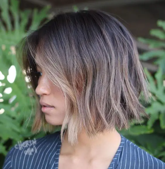 a choppy bob with darker root and bronde and blonde balayage, with texture and volume looks fresh and cool