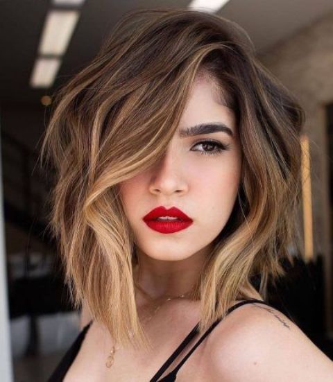 a dark brown bob with blonde and bronde balayage and a money piece to highlight the face looks amazing