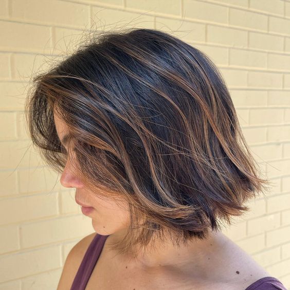 a dark textural bob with caramel balayage and babylights looks dimensional, voluminous and very chic