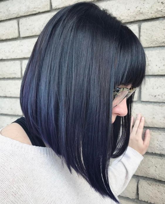 a deep blue angled long bob with a fringe is a lovely and bold idea that strikes with its color and angle