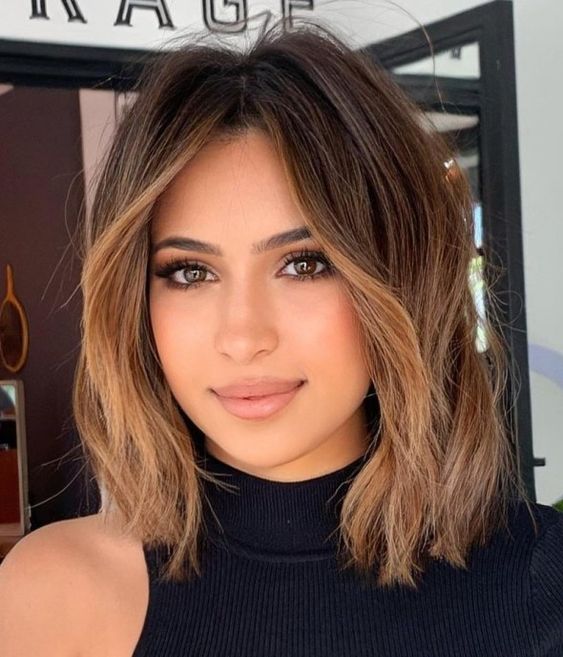 a killer brown bob with caramel balayage and a money piece to highlight the face looks gorgeous