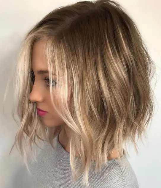 a light brown bob with blonde balayage and messy waves and texture is a lovely idea to rock
