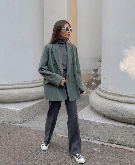 a minimalist fall look with a grey turtleneck, grey pants, a light green blazer and printed sneakers is simple yet cool