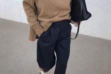 a minimalist fall outfit with a beige turtleneck sweater, navy pants, creamy slingbacks and a large black bag for work