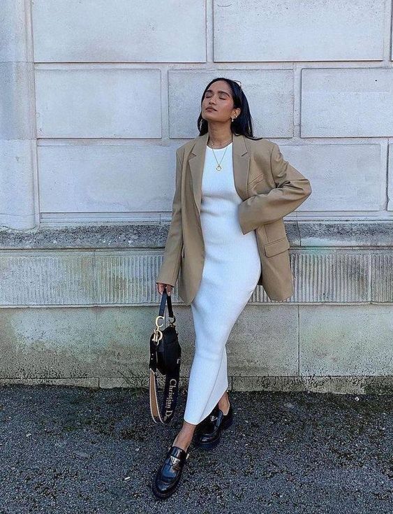 a minimalist work outfit with a white midi dress, an oversized beige blazer, black loafers and a black bag