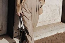 a monochromatic fall outfit with a light grey turtleneck, pants, a beige blazer, brown boots and a black bag
