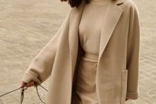 a romatic and minimal fall look with a creamy turtleneck, a beige leather skirt, a neutral coat and a semi circle bag
