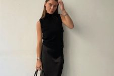 a total black look with a sleeveless top, a maxi skirt, peep toe shoes and a large tote for work