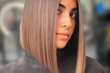 an eye-catchy long asymmetrical bob in caramel tones is a very catchy, bold yet soft idea due to the shades chosen
