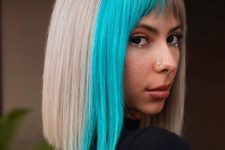 an ultra-modern and edgy solution – a silver blonde long bob with a bright blue fringe and bangs only on one side