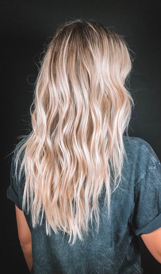 beach blonde balayage with a darker root, with icy blonde touches and a beach texture is chic