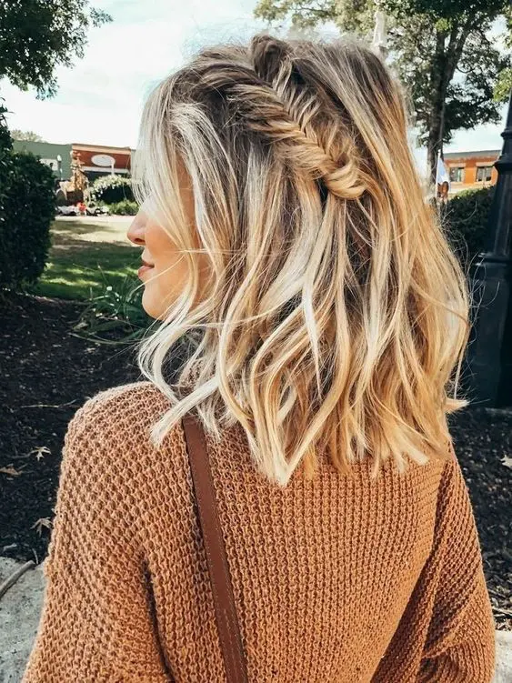 beachy blonde balayage with waves and a fishtail braid on one side are a great idea to give a summer feel to your look