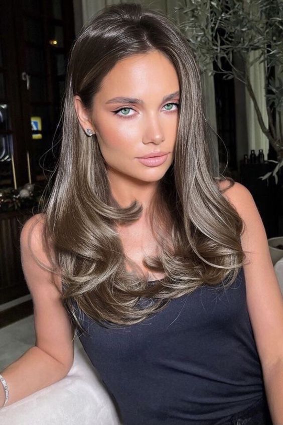 beautiful long mousy brown hair with a touch of shine and messy waves is a lovely idea to look chic