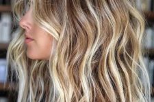 light brown hair of medium length with icy and beachy blonde balayage and babylights plus a texture for a beachy look