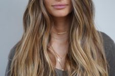 light brunette hair with long honey blonde highlights and waves is a cool idea to wear in summer