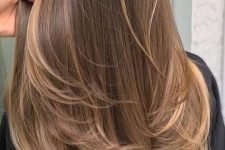 long brown hair with long sunkissed and mushroom blonde balayage and a bit of ombre at the ends is very cool