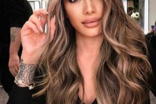 long brunette hair with caramel and blonde highlights and waves looks gorgeous and very chic