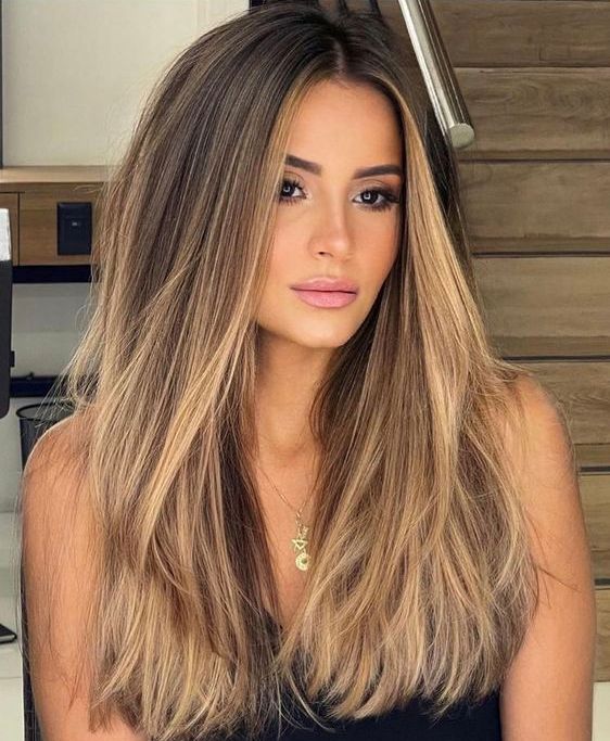 long dark brown hair with caramel balayage and babylights is a beautiful solution with much dimension and a beachy feel