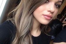 long mousy brown hair with a bit of highlights and messy waves at the ends is a cool idea to try right now