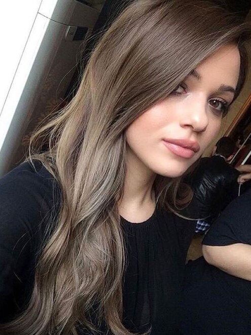long mousy brown hair with a bit of highlights and messy waves at the ends is a cool idea to try right now