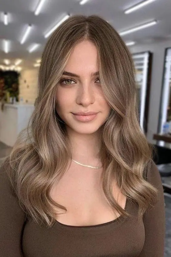 long mousy brown hair with central parting and a bit of blonde babylights, with waves is a gorgeous idea for a delicate look