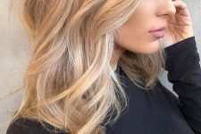 lovely blonde beach hair with a darker root, with balayage and babylights and just a bit of texture and waves