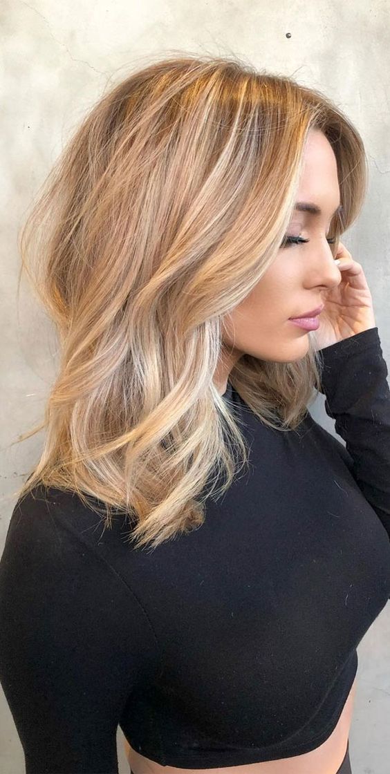 lovely blonde beach hair with a darker root, with balayage and babylights and just a bit of texture and waves